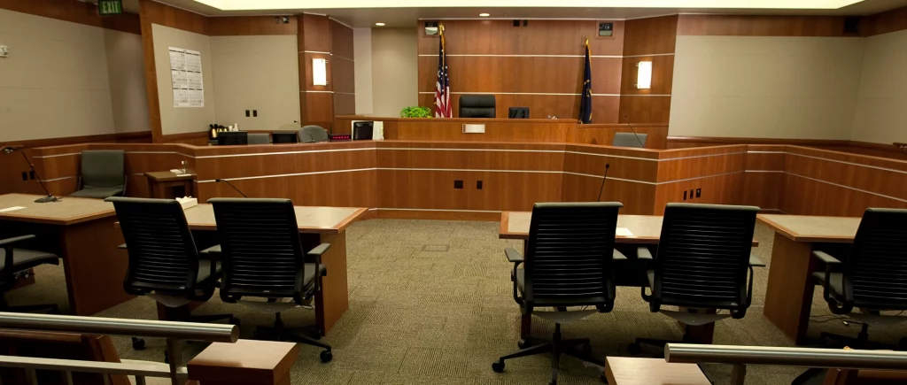Inside an empty courtroom where an arraignment would take place.